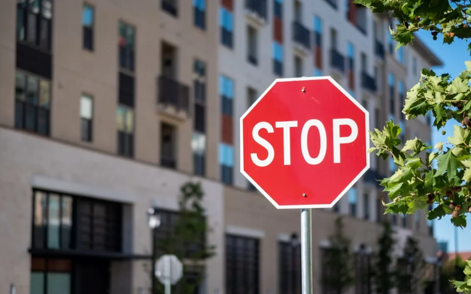 Rotes Stoppschild vor einer Hausfassade